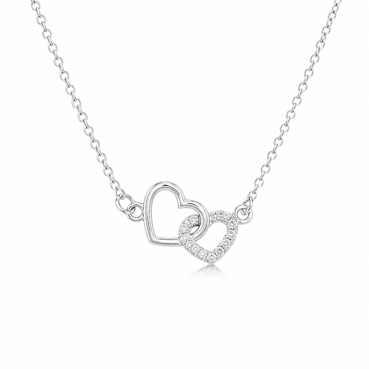 Éternelle double heart pendant on a soft blush background